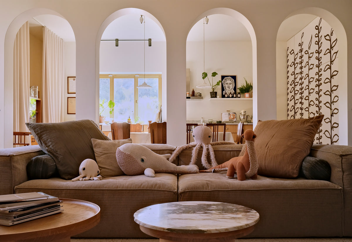 Giant stuffed animals on a sofa in a living room