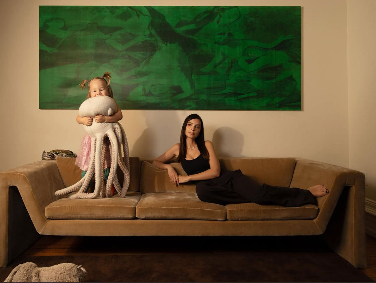 Giant octopus plush on a sofa with its family